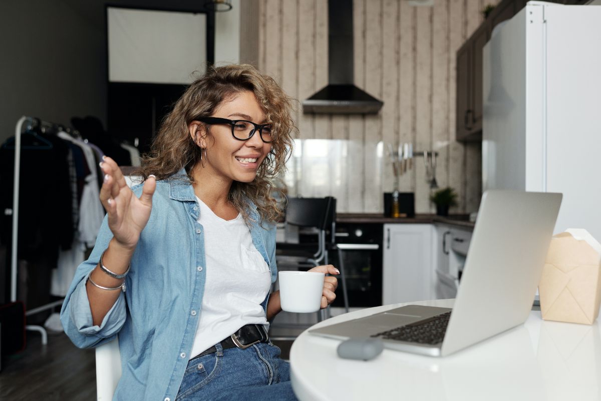 Woman with coffee on a video conference call